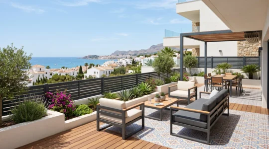 Terraza española contemporánea con suelo de baldosas, mobiliario de jardín discreto y valla de aluminio con lamas horizontales al fondo bajo luz natural brillante